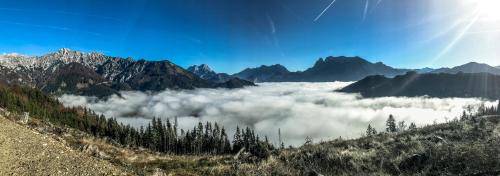 a view of a valley of clouds in the mountains at Haus Rosina in Admont