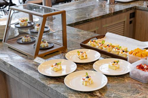 a bunch of desserts on plates on a counter at Hualien Farglory Hotel in Yanliau