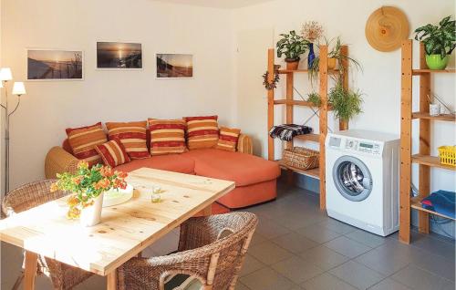 a living room with a couch and a table at Stunning Home In Grzybowo in Grzybowo