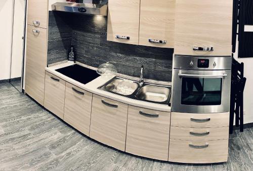 a kitchen with a sink and a stove at Residence Toraldo in Rome