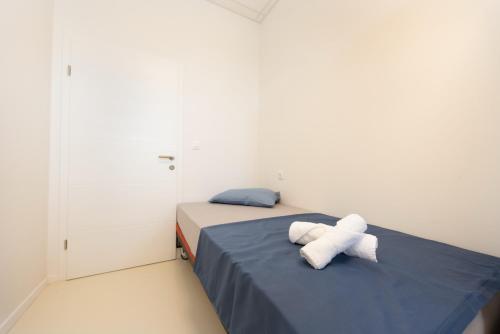 a bedroom with a bed with two towels on it at Hostel Potpican in Potpićan