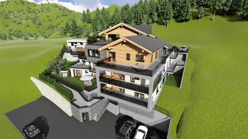 eine Luftansicht eines Hauses mit vor dem Haus geparkt in der Unterkunft Relax Apartments Ladis in Ladis