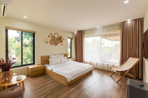 a bedroom with a bed and a large window at Phong Sơn Villa - Venuestay in Hanoi