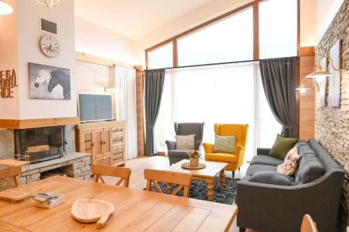 a living room with a couch and a table at Villa Raphael near the Bansko Ski Resort in Razlog
