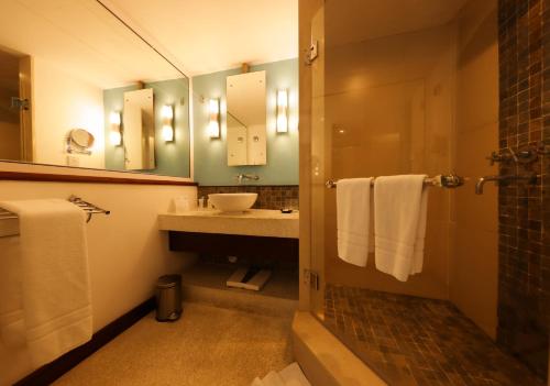 a bathroom with a sink and a mirror at Laguna Beach Hotel & Spa in Grande Rivière Sud Est