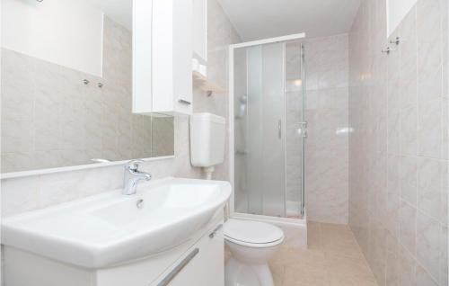 a white bathroom with a sink and a toilet at Stunning Apartment In Jelsa With 1 Bedrooms And Wifi in Jelsa