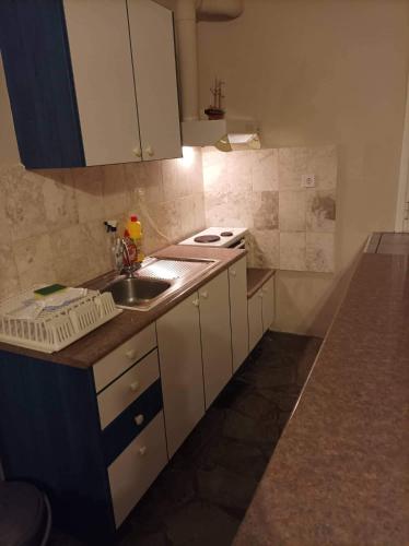 a small kitchen with a sink and a stove at Holiday Tolofona Beach in Eratini
