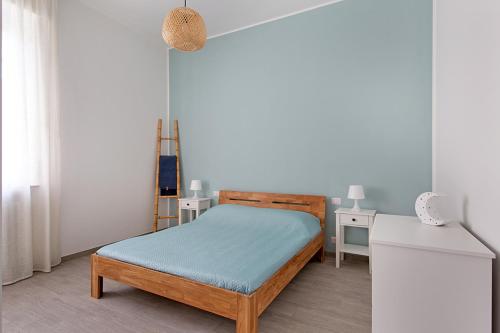 a small bedroom with a bed and a table at Casa Luna in Novara