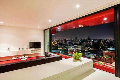 a living room with a couch and a large window at 1866 Court & Suites Hotel in Beirut