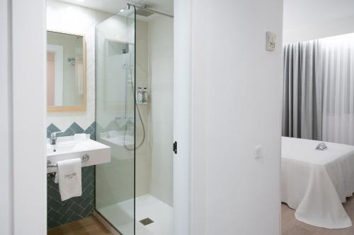 a bathroom with a sink and a shower at Sercotel Carlos III in Cartagena