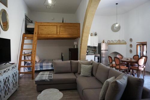 a living room with a couch and a loft bed at Amalia's Traditional Home in Paradisi in Paradeísion