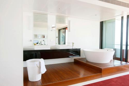 a bathroom with a large white tub and a sink at 1866 Court & Suites Hotel in Beirut