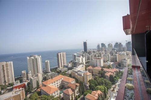 an aerial view of a city with buildings and the ocean at 1866 Court & Suites Hotel in Beirut