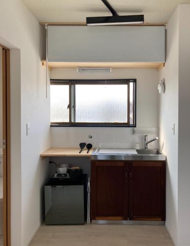 a kitchen with a sink and a window at SLEEEP Fuji in Fujinomiya