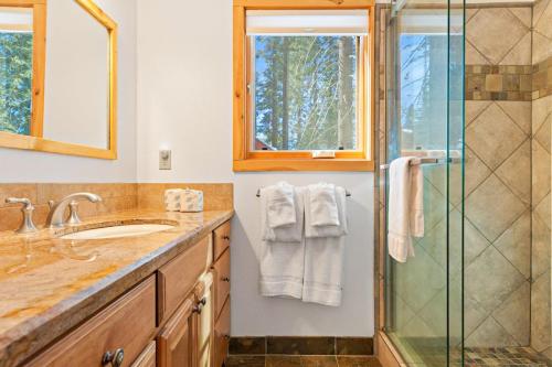a bathroom with a shower and a sink at Oso Lodge in Yosemite West
