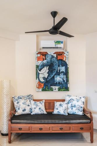 a couch in a room with a ceiling fan at Luz_ita Sunshine Villa in Uluwatu