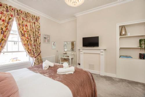 a bedroom with a bed with two towels at George Street Boutique Apartments in York