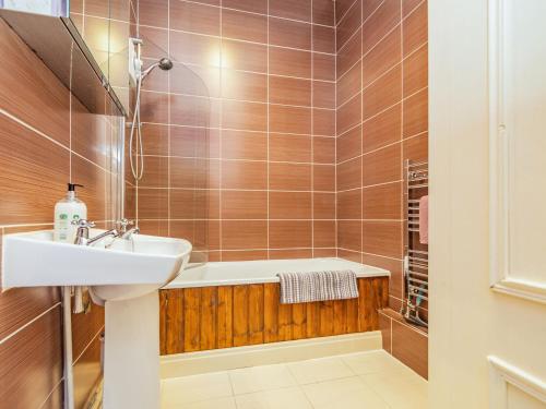 a bathroom with a sink and a bath tub at Anglers Cottage in Skipton