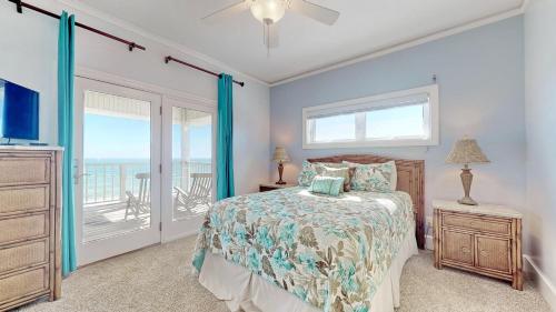 a bedroom with a bed and a balcony at Barefoot Bungalow in St. George Island