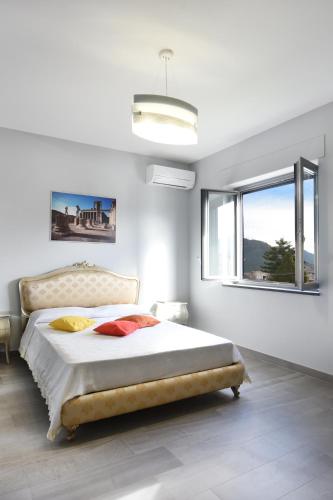 a bedroom with a large bed and a window at Villa Ida - Free private Parking in Sarno
