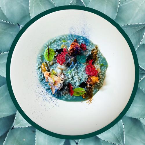 a plate of food with fruit and rice on a table at I Capricci Di Merion - Resort & Spa in Tuoro sul Trasimeno