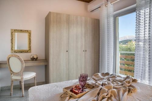 a bedroom with a bed with a table and a window at Malibu Superior Apartment in Argostoli