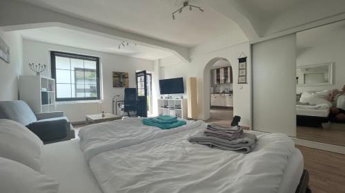 a living room with a large bed with towels on it at OASE im grünen Hinterhof, EG, Ruhe, Terrasse, Carport, free PayTV, Kaffee&Tee, Fahrräder in Duisburg