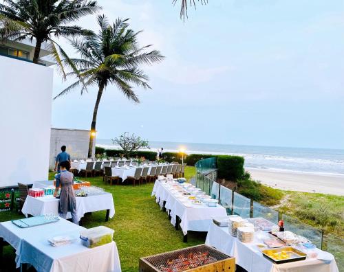 a table set up for a party at the beach at The Ocean Villas Managed by The Ocean Resort in Da Nang