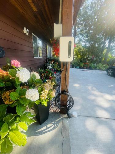 a house with flowers and a phone on a porch at Garden Bridge House in Sechelt