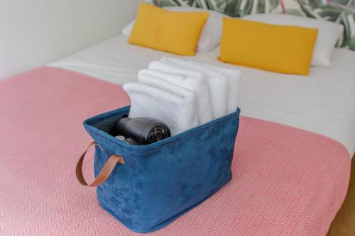 a blue bag sitting on top of a bed at The Amsterdam Houseboat Family - de Jordaan in Amsterdam