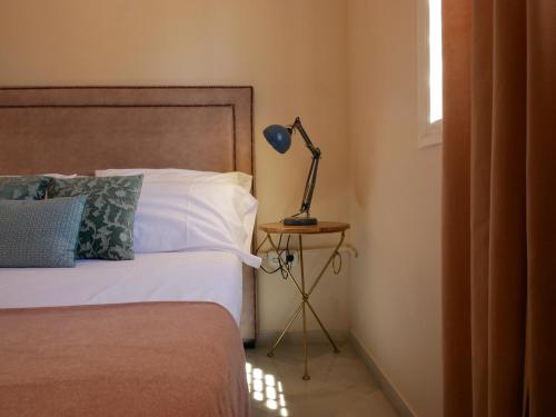 a bedroom with a bed and a lamp on a table at Sierpes 50 in Seville