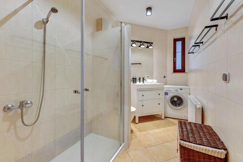 a bathroom with a shower and a washing machine at Lion Apartments - Amalfi Quiet Family 3 Bedr Apartment in Sopot
