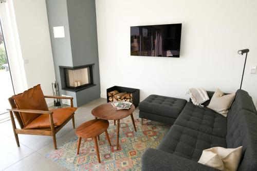 a living room with a couch and a table at Seehaus Mühlfeld in Löbnitz