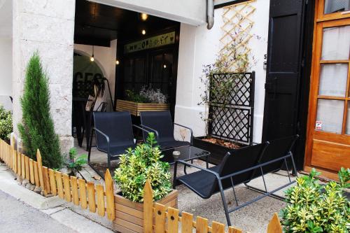 a restaurant with black chairs in front of a building at Eau Berges in Vicdessos