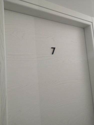 a white door with the number seven on it at B&B Roseal in Brusciano