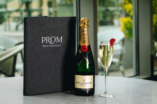 a bottle of champagne and a glass on a table at Salthill Hotel in Galway