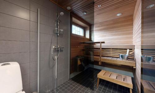 a bathroom with a shower and a toilet and a bench at Hilmantori Apartments by Hiekka Booking in Kalajoki