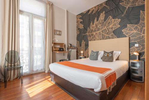 a bedroom with a large bed with two pillows at Hôtel Cecil Adults only in Juan-les-Pins