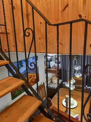 a spiral staircase in a room with wooden ceilings at Misty peaks Cloudlands in Bergview