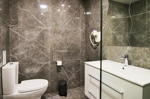a bathroom with a toilet and a sink at Phaedrus Living: Luxury Suite Nicosia 507 in Nicosia