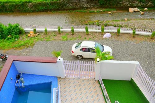 an aerial view of a car parked in a parking lot at River Stay - Homestay by Wanderlust Rural Tourism in Dehradun