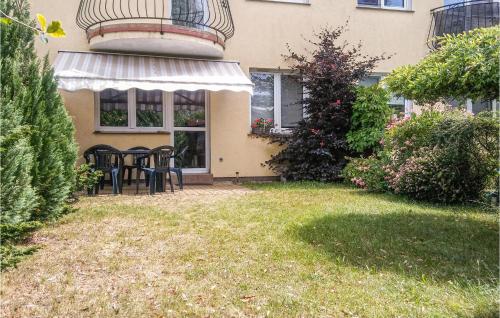 a house with a table and chairs in the yard at Gorgeous Apartment In Darlowo With Wifi in Darłowo