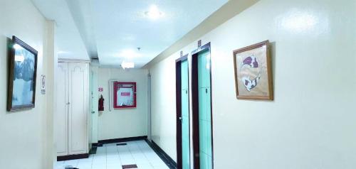 a hallway with white walls and glass doors in a building at Demiren Hotel in Cagayan de Oro
