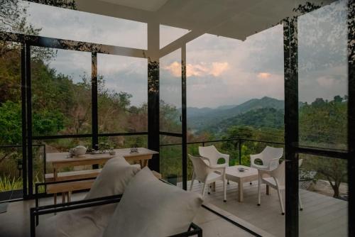 a glass house with a view of the mountains at Casa Del Sol - Luxury Villa in Bolepe
