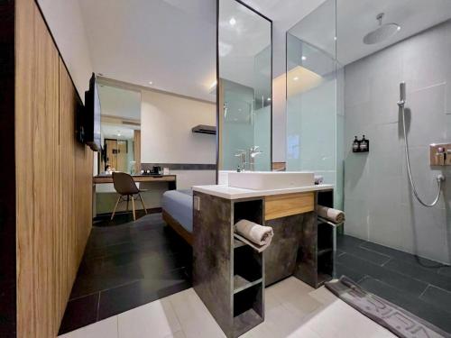 a bathroom with a sink and a shower at Erian Hotel in Jakarta