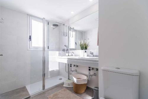 a white bathroom with a sink and a shower at 71-Beachfront, brand new luxury penthouse Benalmádena in Benalmádena