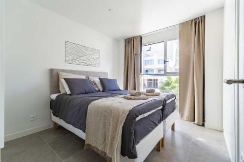 a bedroom with a bed and a large window at 71-Beachfront, brand new luxury penthouse Benalmádena in Benalmádena