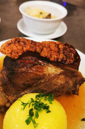 a plate of food with two pieces of meat and potatoes at Landgasthof Büttel in Geisfeld