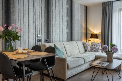 a living room with a couch and a table at InPoint Apartments G15 near Old Town & Kazimierz District & Optional Paid Parking in Kraków