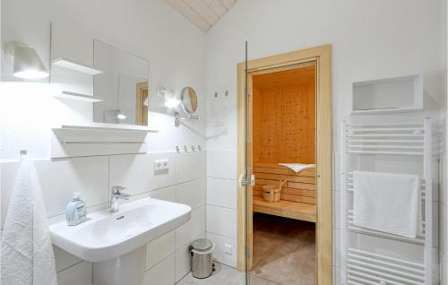 a white bathroom with a sink and a shower at Gorgeous Home In Krems Iiwarderbrück in Göls